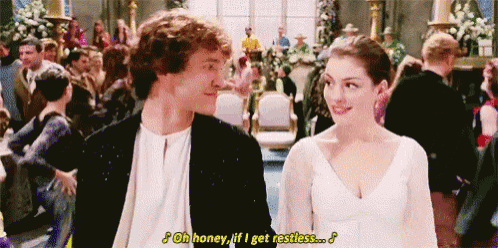 a man and a woman are standing next to each other in front of a crowd at a wedding reception .