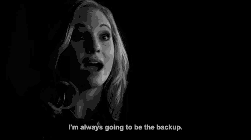 a black and white photo of a woman in a dark room with a quote .