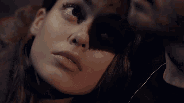 a close up of a woman 's face with a shadow on it