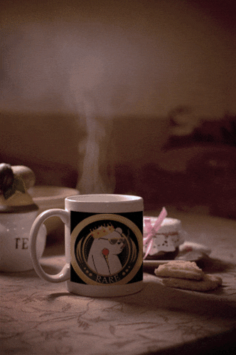 a coffee mug that says rare on it sits on a table