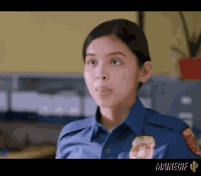 a woman in a police uniform has a patch on her chest that says ' mainegif ' on it