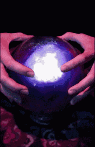a person is holding a purple ball with a white light coming out of it
