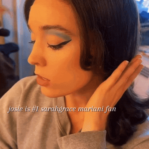 a close up of a woman 's face with josie is # 1 sarahgrace mariani fan written on the bottom