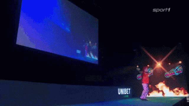 a person standing in front of a large screen that says peter wright on it