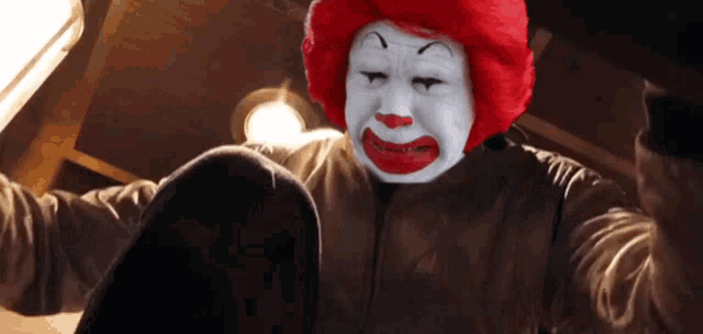 a man in a mcdonald 's clown costume with red hair