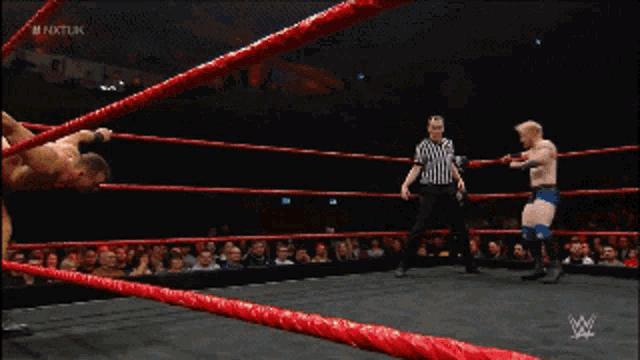 two men are wrestling in a ring with the words nktlink on the bottom left