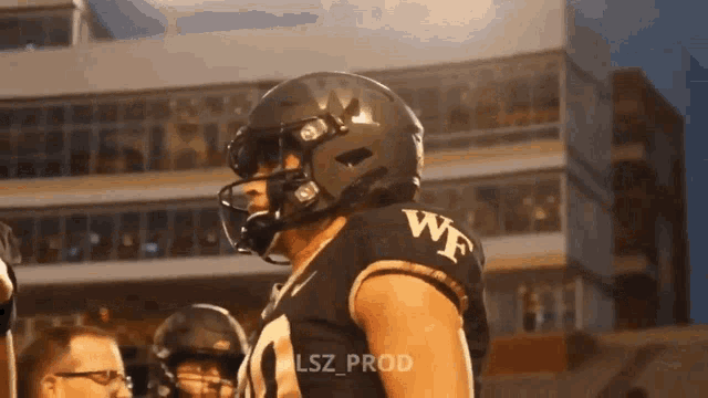 a football player wearing a helmet with the word wf on the back