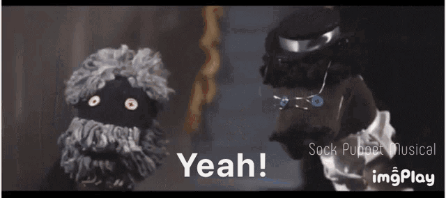 a sock puppet says " yeah " in front of another sock puppet