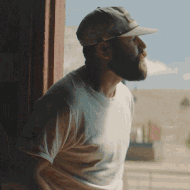 a man with a beard wearing a baseball cap