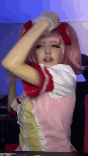 a girl with pink hair is wearing a pink and red outfit