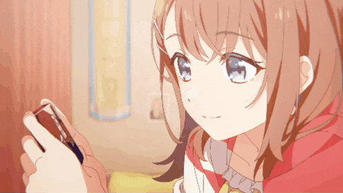a girl with red hair and blue eyes is looking at a cell phone