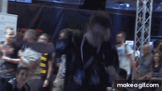 a blurry photo of a crowd with the words make a gif.com visible
