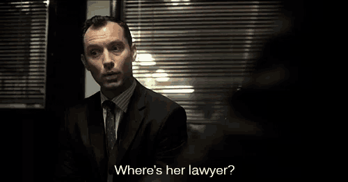 a man in a suit and tie is asking where is her lawyer