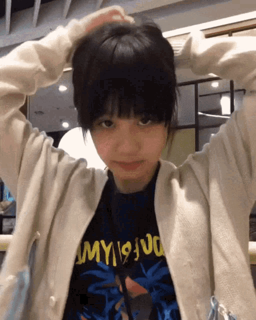 a girl wearing a sweater and a shirt that says ' my 19 ' on it