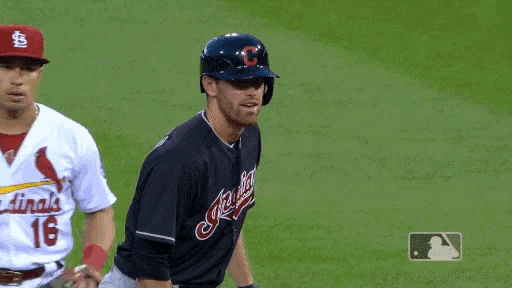 two baseball players one from the indians and the other from the cardinals are on the field