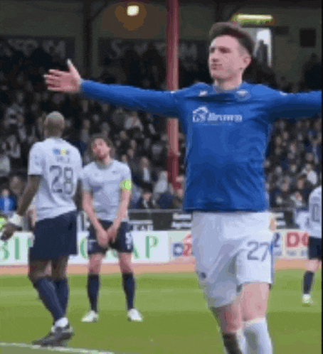 a soccer player with the number 27 on his shorts is standing on the field
