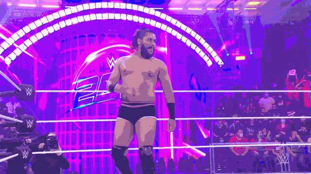 a wrestler in a wrestling ring with a purple background