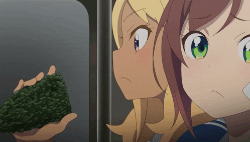 a girl with green eyes is holding a piece of broccoli