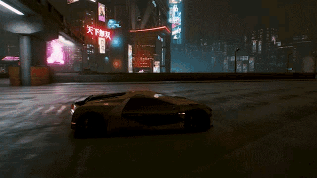 a car is driving down a street at night with chinese writing on the side