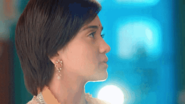 a close up of a woman 's face with a blurry background