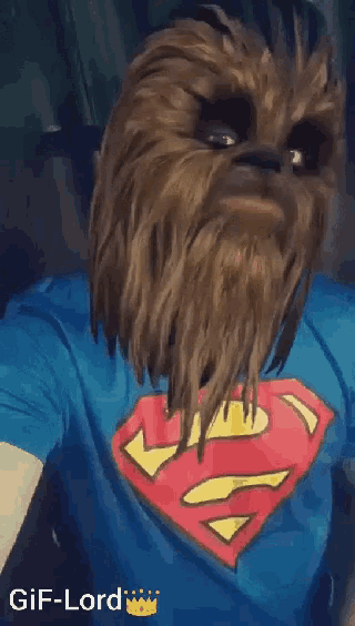 a gif of a chewbacca with a superman shirt on