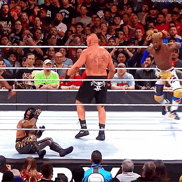 a man in a wrestling ring has a tattoo on his back