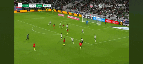 a soccer game is being played in a stadium with ads for wells fargo and coca cola