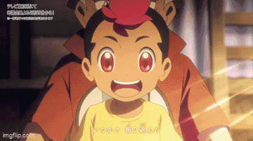 a little boy with red eyes is being held by a man in a yellow shirt .