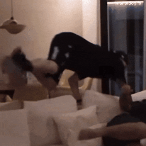 a person is doing a handstand on a couch with a caption that says ' mamadogs '