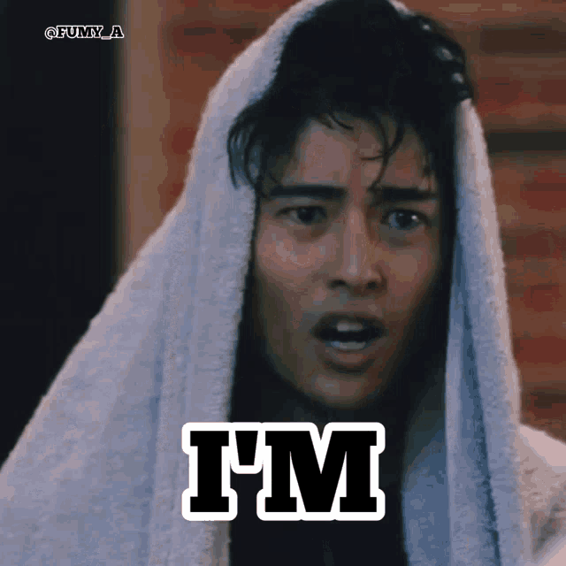a man with a towel wrapped around his head has the word i 'm on his face