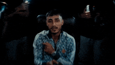 a blurry picture of a man sitting in a chair