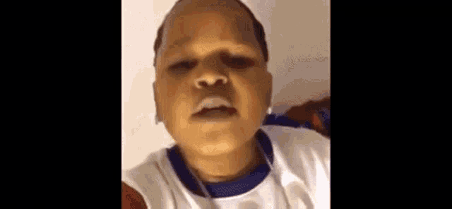 a young boy is making a funny face in a video .
