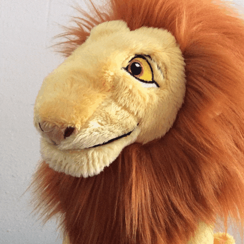 a close up of a stuffed lion 's face