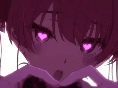 a close up of a girl making a heart shape with her hands