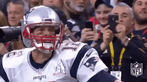 a patriots football player is taking a picture of himself in front of the crowd .