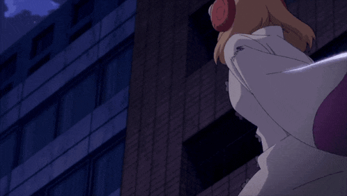 a woman wearing headphones stands in front of a tall building