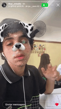 a man with a dalmatian mask on his face is taking a selfie .