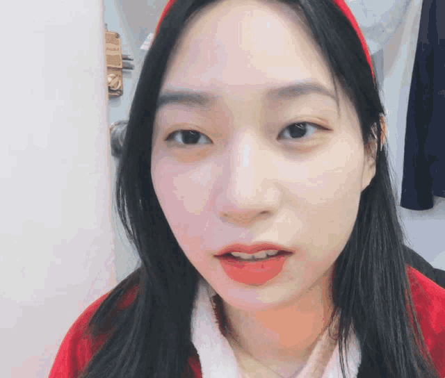 a close up of a woman 's face with a red headband on her head