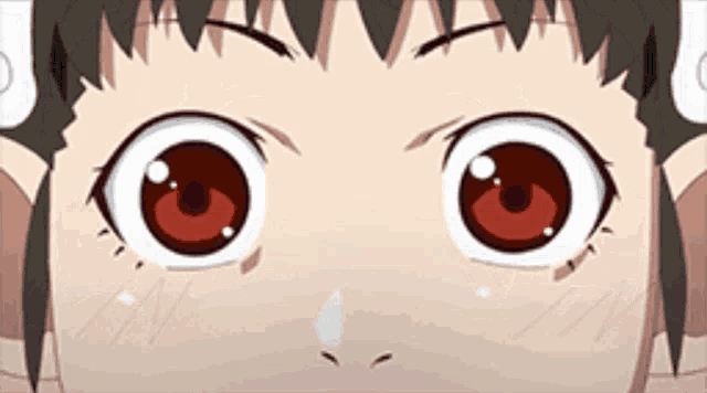 a close up of a person 's eyes with a tear coming out of them .