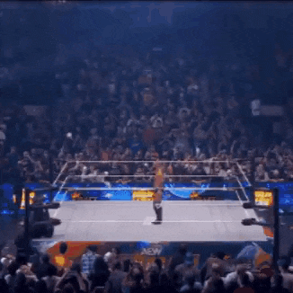 a man is standing in a wrestling ring with a bunch of ribbons coming out of him .