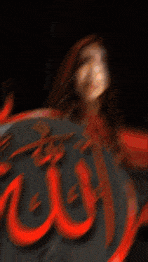 a blurry picture of a woman holding a circle of fire with the letter o in the background