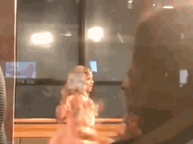 a man is looking at a statue of a woman in a pink dress .
