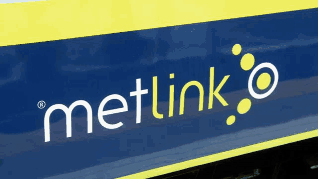 a metlink logo is on the side of a train