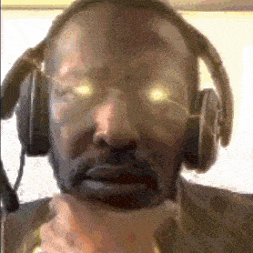 a close up of a man wearing headphones and a microphone .