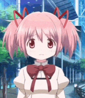 a girl with pink hair and a red bow on her neck is standing in front of a building in a city .