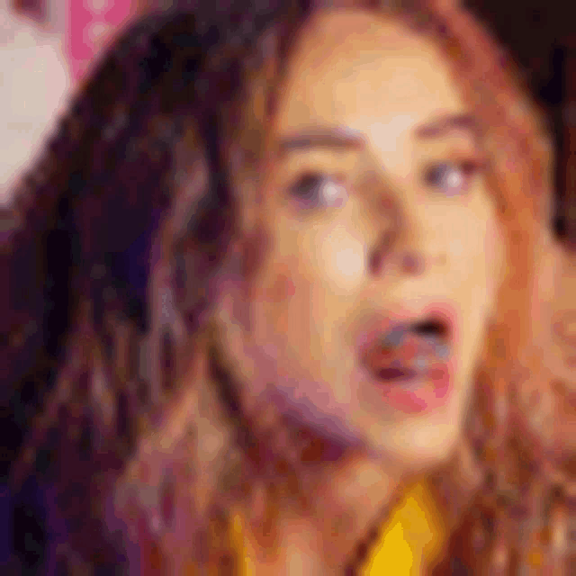 a close up of a woman 's face with a surprised expression .