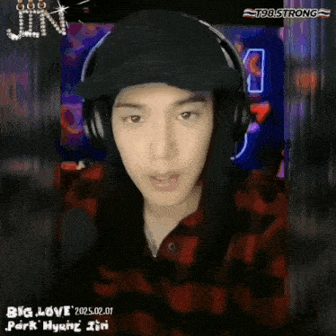 a young man wearing headphones and a plaid shirt with the words big love written on the bottom