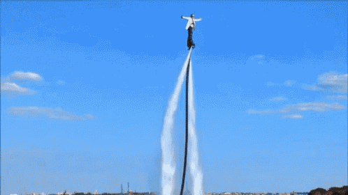 a person is flying through the air in front of a crowd of people