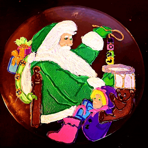 a painting of santa claus is on a plate with a drum