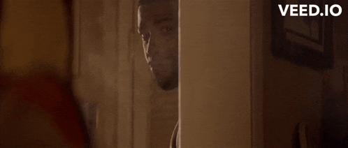 a man peeking out from behind a wall with the words you know i 'm surgical with this bitch